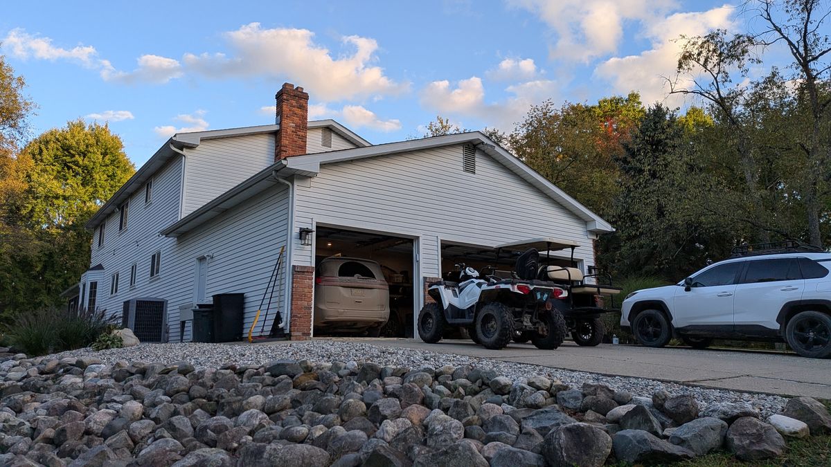 Garage end of the house with the brick chimney rising behind it