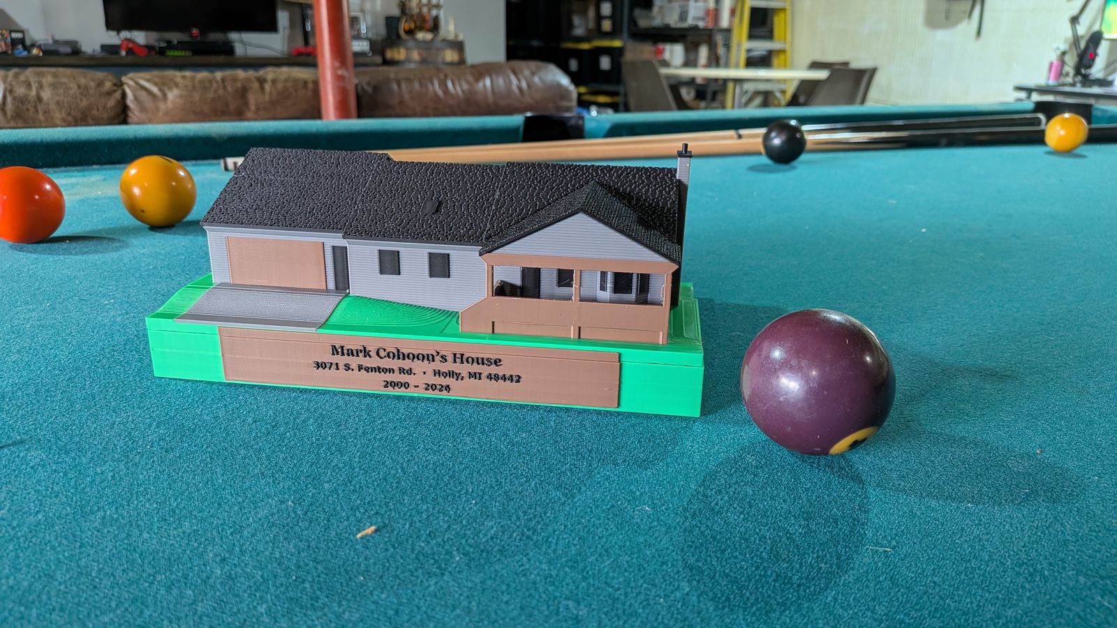 The front of the mini with the garage, porch, and nameplate
