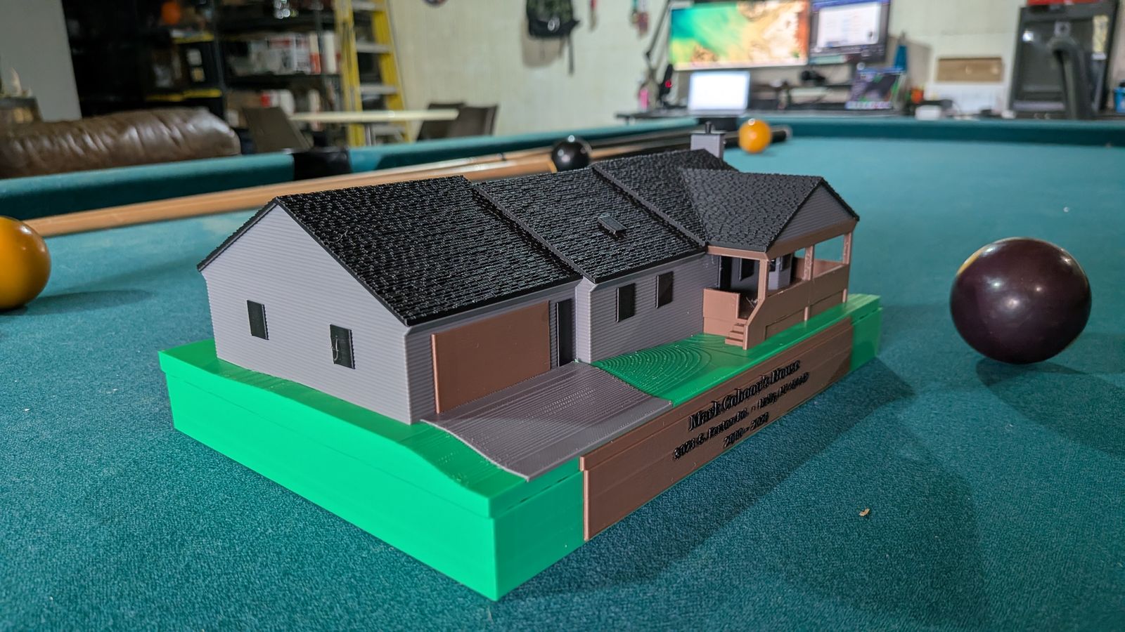 The finished HouseMini of Mark Cohoon's house: gray siding, textured black shingles, a brown porch, and a green lawn base