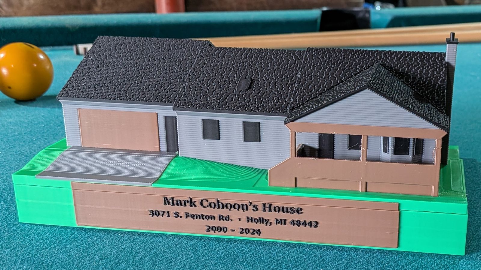Close-up of the mini's front with its nameplate reading Mark Cohoon's House, 2000 to 2026