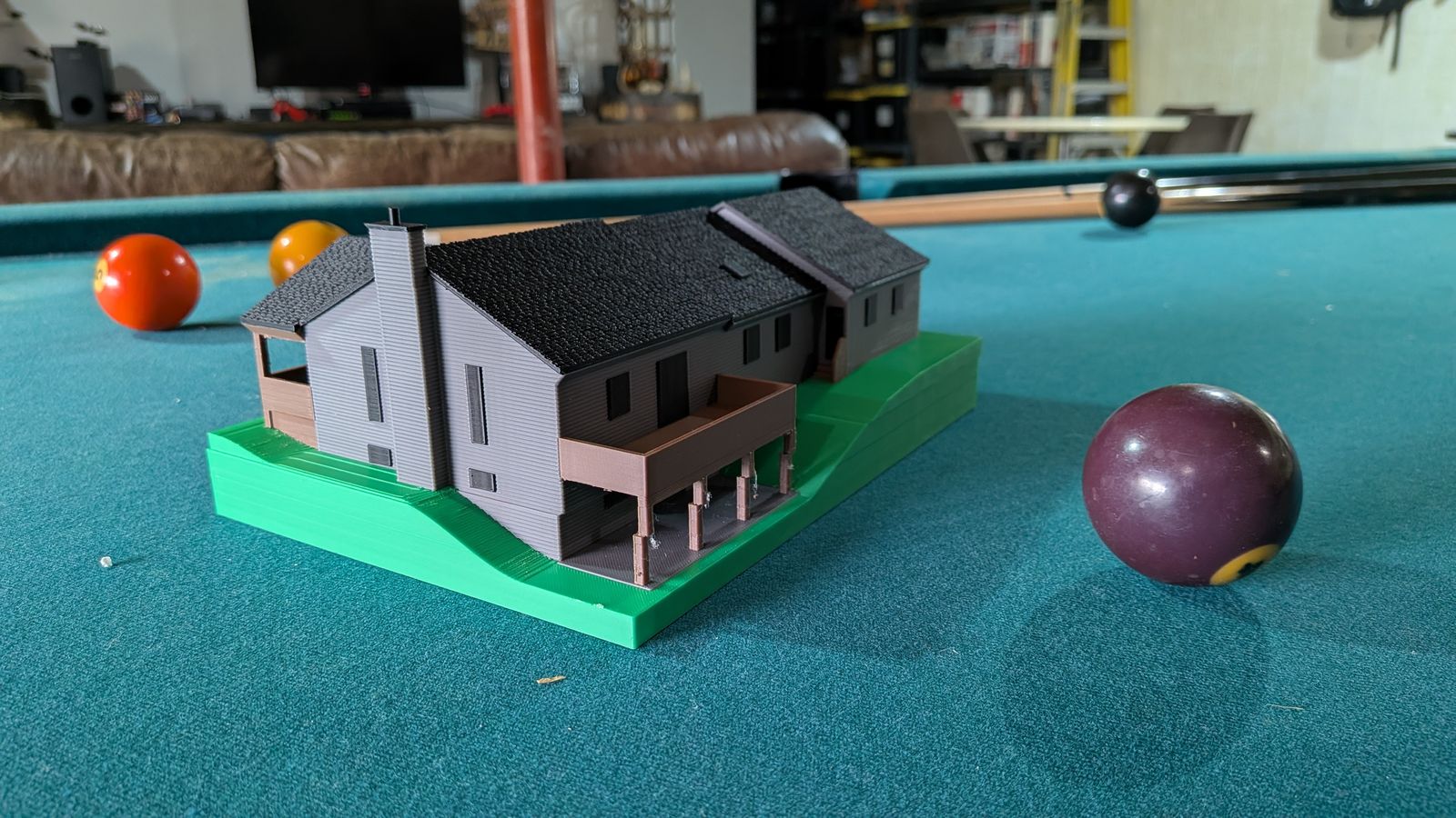 The back of the mini: sloped lawn, deck on posts, and the chimney